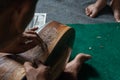 A guitar craftsman are carving a classical guitars made from wood, with Balinese pattern, in a wooden guitar workshop at Guwang