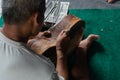 A guitar craftsman are carving a classical guitars made from wood, with Balinese pattern, in a wooden guitar workshop at Guwang