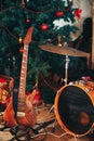 Guitar and drum under the Christmas tree Royalty Free Stock Photo