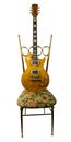 Guitar exempted standing on a chair Royalty Free Stock Photo