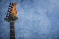 Guitar with fir tree branch on light blue background, space for text. Christmas music Royalty Free Stock Photo