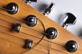 Guitar fretboard with tuning pegs and strings on a gray background. Close-up Royalty Free Stock Photo