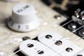 Guitar fretboard with tuning pegs and strings on a gray background. Close-up Royalty Free Stock Photo