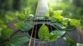 Guitar with green leaves on strings, nature harmony concept Royalty Free Stock Photo