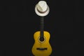 Guitar and hat in the dark. acoustic musical instrument. strings on the guitar neck Royalty Free Stock Photo