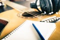 Guitar and Headphone with blank notebook