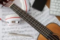 Guitar headphones and musical notes on table closeup Royalty Free Stock Photo