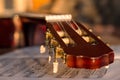 Guitar headstock on old music notes, close up Royalty Free Stock Photo