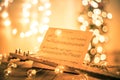 Guitar with instrumental sheet music and soft lights for Christmas holiday, split tone