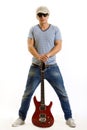 Guitar between the legs of a guitarist Royalty Free Stock Photo