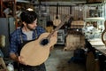 Guitar Luthier Examines Wood for Acoustic Guitar Neck