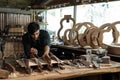 Guitar luthier ties rope, drives wedge to join spruce wood boards Royalty Free Stock Photo