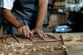 Guitar luthier using small planer to fine-tune bracing of acoustic guitar