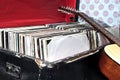 Guitar lying against trunk with vinyl records Royalty Free Stock Photo