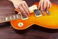 Guitar master adjusts intonation on electric guitar at workplace Royalty Free Stock Photo