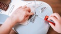 Guitar master repairing electric guitar, top view, closeup