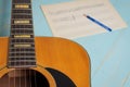 Guitar music sheet and pencil on wooden table Royalty Free Stock Photo