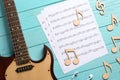 Guitar neck and sheets with music notes on color Royalty Free Stock Photo