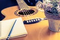 Guitar and notebook for love writing equipment flower bucket. Royalty Free Stock Photo