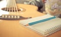 Guitar with notebook for music songwriting