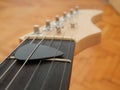 Guitar pick between the strings Royalty Free Stock Photo