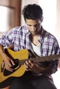 Guitar, play and man in recording studio with musician writing music with creativity. Artist, talent and skill with