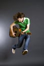 Guitar player jumping in midair Royalty Free Stock Photo