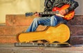 Guitar player with open guitar case