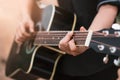 Guitar player playing acoustic guitar, close up