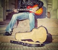 Guitar player on the stairs in vintage tone Royalty Free Stock Photo