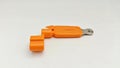 Guitar Restringing Tool. A vivid orange guitar string winder and cutter combo tool, isolated on a white studio background. Royalty Free Stock Photo