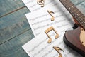 Guitar and sheets with music notes on table. Space for text Royalty Free Stock Photo