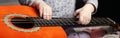 Guitar and small children hands. music themed panoramic shot Royalty Free Stock Photo