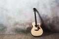 The guitar stands near the wall in the style of grunge, music, musician, hobby, lifestyle, hobby Royalty Free Stock Photo