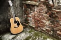 The guitar stands near the wall Royalty Free Stock Photo