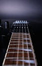 Guitar stringsand fretboard, close up. Electric guitar. .Soft selective focus. On black