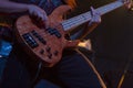 Guitar strummed by guitar player in concert