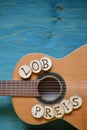 Guitar on teal wood with the word: LOBPREIS Royalty Free Stock Photo