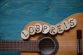Guitar on teal wood with the word: LOBPREIS Royalty Free Stock Photo
