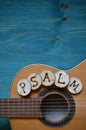 Guitar on teal wood with the word: PSALM Royalty Free Stock Photo