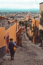 A Mexican guitar player walks on the streets of San Miguel de Allende