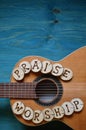 Guitar on wood with words: PRAISE and WORSHIP Royalty Free Stock Photo