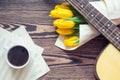 Guitar, yellow tulips, cup of coffee, musical page