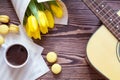 Guitar, yellow tulips, cup of coffee, musical page