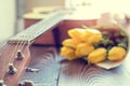 Guitar, yellow tulips, musical page