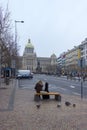 Guitarist with guitar sitting on bench in Prag