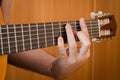 Guitarist hand playing acoustic guitar