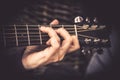 Guitarist Playing song on acoustic guitar fretboard chord vintage style