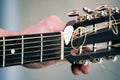 Guitarist hand tuning classic acoustic guitar. Royalty Free Stock Photo