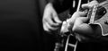 Guitarist hands and guitar close up. playing electric guitar. copy spaces. black and white. Royalty Free Stock Photo